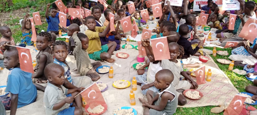 Children with plates of food during a community feeding day
