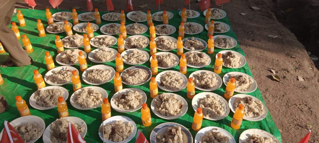 Plates of food laid out for distribution to families